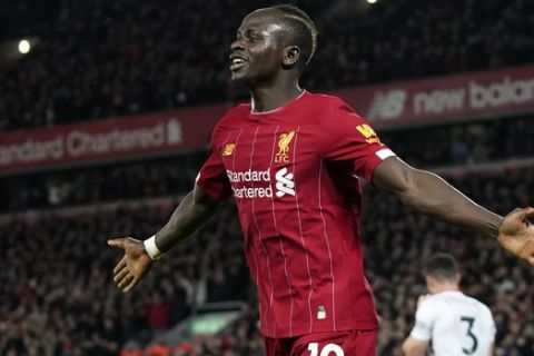 Liverpool's Sadio Mane celebrates after scoring his side's second goal during the English Premier League soccer match between Liverpool and Sheffield United at Anfield Stadium, Liverpool, England, Thursday, Jan. 2, 2020. (AP Photo/Jon Super)