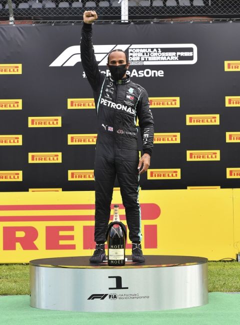 Mercedes driver Lewis Hamilton of Britain celebrates on the podium after winning the Styrian Formula One Grand Prix at the Red Bull Ring racetrack in Spielberg, Austria, Sunday, July 12, 2020. (Joe Klamar/Pool via AP)