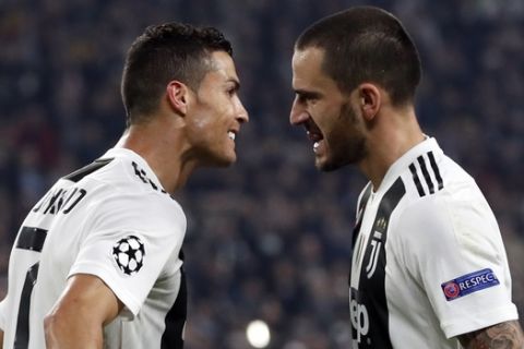 Juventus forward Cristiano Ronaldo celebrates with teammate Leonardo Bonucci, right, after scoring his side's opening goal during the Champions League group H soccer match between Juventus and Manchester United at the Allianz stadium in Turin, Italy, Wednesday, Nov. 7, 2018. (AP Photo/Antonio Calanni)