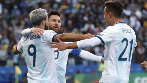 Argentina's Sergio Aguero, left, celebrates with teammates Lionel Messi, center, and Paulo Dybala after scoring his side's opening goal against Chile during Copa America third-place soccer match at the Arena Corinthians in Sao Paulo, Brazil, Saturday, July 6, 2019. (AP Photo/Victor R. Caivano)