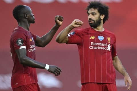 Liverpool's Mohamed Salah, right, celebrates after scoring the second goal with Sadio Mane during the English Premier League soccer match between Liverpool and Crystal Palace at Anfield Stadium in Liverpool, England, Wednesday, June 24, 2020. (Paul Ellis/Pool via AP)