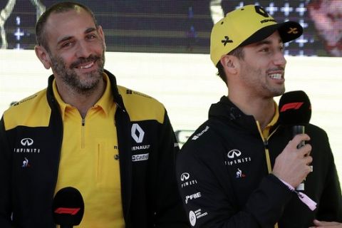 Renault driver Daniel Ricciardo of Australia, right, talks as teammate Nico Hulkenberg of Germany, left, and team principal Cyril Abiteboul listen during the launch for the Australian Grand Prix in Melbourne, Australia, Wednesday, March 13, 2019. (AP Photo/Rick Rycroft)