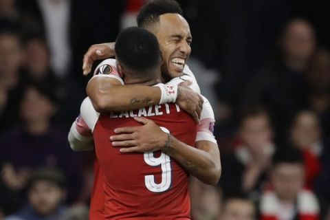 Arsenal's Pierre-Emerick Aubameyang, right, celebrates with his teammate Alexandre Lacazette after scoring his side's third goal during the Europa League semifinal first leg soccer match between Arsenal and Valencia at the Emirates stadium in London, Thursday, May 2, 2019. (AP Photo/Kirsty Wigglesworth)