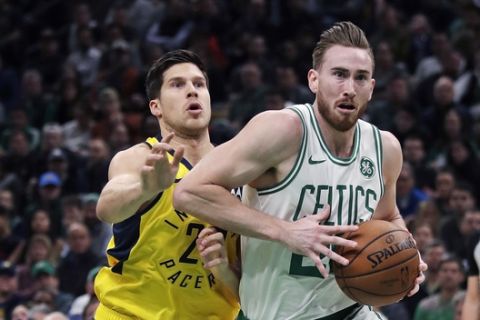Boston Celtics forward Gordon Hayward, right, drives to the basket past Indiana Pacers forward Doug McDermott, left, during the second quarter of an NBA basketball game in Boston, Wednesday, Jan. 9, 2019. (AP Photo/Charles Krupa)