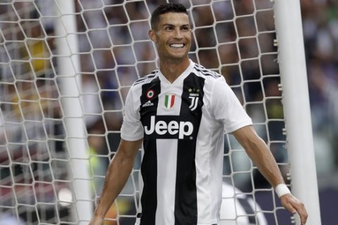 Juventus' Cristiano Ronaldo smiles after his teammate Juventus' Mario Mandzukic scored his sides second gaol of the game during the Serie A soccer match between Juventus and Lazio at the Allianz Stadium in Turin, Italy, Saturday, Aug. 25, 2018. (AP Photo/Luca Bruno)