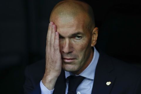 Real Madrid's head coach Zinedine Zidane sits on the bench during the Champions League group A soccer match between Real Madrid and Club Brugge, at the Santiago Bernabeu stadium in Madrid, Tuesday, Oct.1, 2019. (AP Photo/Manu Fernandez)