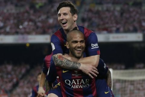 Barcelona's Lionel Messi, left, celebrates with Dani Alves after scoring his sides third goal during the final of the Copa del Rey soccer match between FC Barcelona and Athletic Bilbao at the Camp Nou stadium in Barcelona, Spain, Saturday, May 30, 2015. (AP Photo/Manu Fernandez)