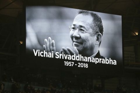An image of Vichai Srivaddhanaprabha is shown inside the stadium as players observe a minute of silence for the victims of the Leicester helicopter crash, before their English League Cup, Fourth Round match against Fulham, at the Etihad Stadium in Manchester, England, Thursday Nov. 1, 2018. (Mike Egerton/PA via AP)
