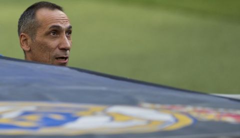 APOEL Nicosia's head coach Giorgos Donis looks out from the bench by a Real Madrid club symbol during a training session in the Santiago Bernabeu stadium in Madrid, Spain, Tuesday, Sept. 12, 2017. APOEL Nicosia will play Real Madrid Wednesday in a Group H Champions League soccer match. (AP Photo/Paul White)