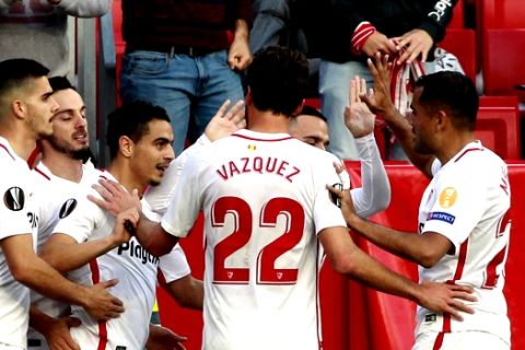 Sevilla's Wissam Ben Yedder, third left, celebrates with teammates after scoring his side's opening goal during the Europa League round of 32 second leg soccer match between Sevilla and Lazio at the Sanchez Pizjuan stadium, in Seville, Spain, Wednesday, Feb. 20, 2019. (AP Photo/Miguel Morenatti)