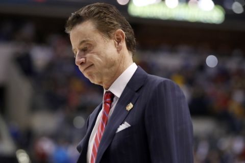FILE - In this Sunday, March 19, 2017, file photo, Louisville head coach Rick Pitino walks off the court after a 73-69 loss to Michigan in a second-round game in the men's NCAA college basketball tournament in Indianapolis. The NCAA is standing by its allegations against the Louisville men's basketball program and Pitino, saying the coach failed to notice "red flags" in activities by a former staffer who an escort says hired dancers for sex parties with recruits and players. (AP Photo/Jeff Roberson, File)