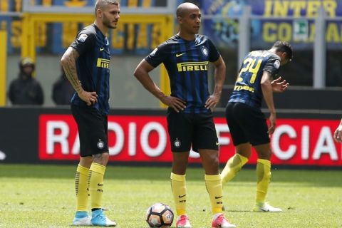 Inter Milan's Mauro Icardi, left, stands with his teammates Joao Mario, center, and Jeison Murillo after Sassuolo's Simone Missiroli scored during the Serie A soccer match between Inter Milan and Sassuolo at the San Siro stadium in Milan, Italy, Sunday, May 14, 2017. (AP Photo/Antonio Calanni)