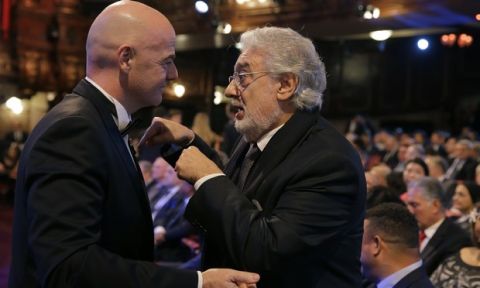 FIFA president Gianni Infantino, left, chats with Opera singer Placido Domingo before the start of The Best FIFA 2017 Awards at the Palladium Theatre in London, Monday, Oct. 23, 2017. (AP Photo/Alastair Grant)