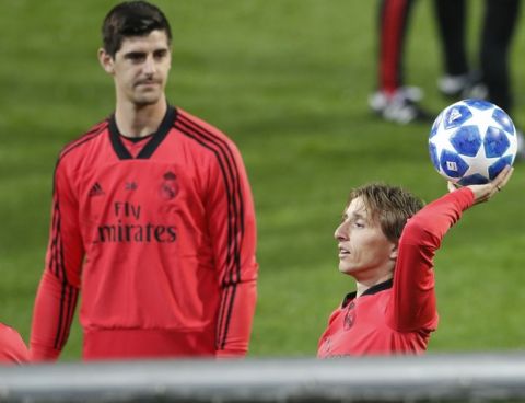 Real goalkeeper Thibaut Courtois, left, watches his teammate Luka Modric, right, tossing a ball during a training session at the Doosan arena in Pilsen, Czech Republic, Tuesday, Nov. 6, 2018. Viktoria Plzen faces Real Madrid in a Champions League group G soccer match on Wednesday. (AP Photo/Petr David Josek)