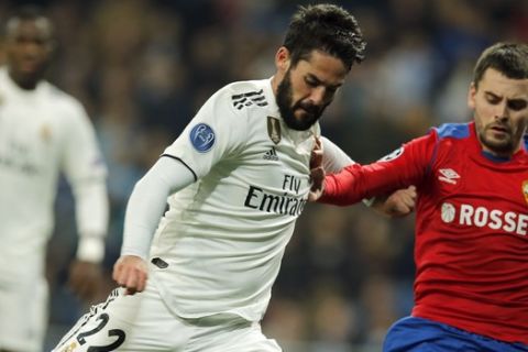 Real midfielder Isco, left, is challenged by CSKA defender Georgi Schennikov during the Champions League, Group G soccer match between Real Madrid and CSKA Moscow, at the Santiago Bernabeu stadium in Madrid, Spain, Wednesday Dec. 12, 2018. (AP Photo/Paul White)