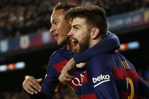 FC Barcelona's Gerard Pique, right, celebrates with his teammate Neymar after scoring against Athletic Bilbao during a quarterfinal, second leg, Copa del Rey soccer match at the Camp Nou stadium in Barcelona, Spain, Wednesday, Jan. 27, 2016. (AP Photo/Manu Fernandez)