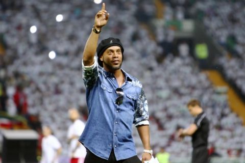 In this photo taken on Sunday, July 16, 2017, Brazilian soccer star and former FC Barcelona player Ronaldinho greets fans at the stadium in Grozny, Russia. Ronaldinho had visited Grozny, Russia, to attend the relaunch of the city's football club. (AP Photo/Musa Sadulayev)