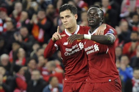 Liverpool's Sadio Mane, right, celebrates with Philippe Coutinho after scoring his side's sixth goal during the Champions League Group E soccer match between Liverpool and Spartak Moscow at Anfield, Liverpool, England, Wednesday, Dec. 6, 2017. (AP Photo/Rui Vieira)