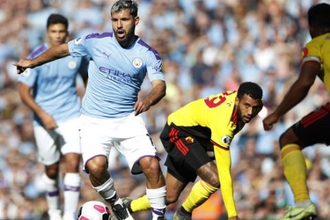 Watford's Etienne Capoue, right, challenges Manchester City's Sergio Aguero, left, during the English Premier League soccer match between Manchester City and Watford at Etihad stadium in Manchester, England, Saturday, Sept. 21, 2019. (AP Photo/Rui Vieira)