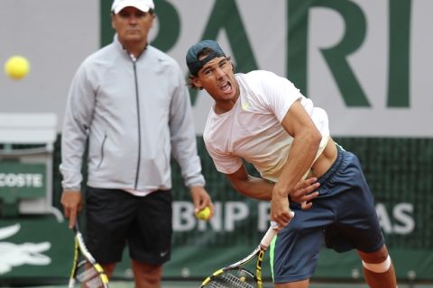 Defending champion Spain's Rafael Nadal trains with his coach Toni Nadal, left, hours before playing his compatriot David Ferrer in the men's final match of the French Open tennis tournament at the Roland Garros stadium Sunday, June 9, 2013 in Paris. (AP Photo/David Vincent)