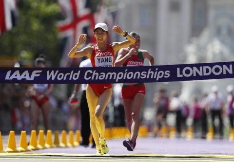 China's Yang Jiayu crosses the line to win gold ahead of silver medal winner Mexico's Maria Guadalupe Gonzalez in the women's 20-kilometer race walk during the World Athletics Championships in London Sunday, Aug. 13, 2017. (AP Photo/Kirsty Wigglesworth)