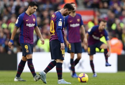FC Barcelona's Lionel Messi reacts after Betis scored their side's second goal during the Spanish La Liga soccer match between FC Barcelona and Betis at the Camp Nou stadium in Barcelona, Spain, Sunday, Nov. 11, 2018. (AP Photo/Manu Fernandez)