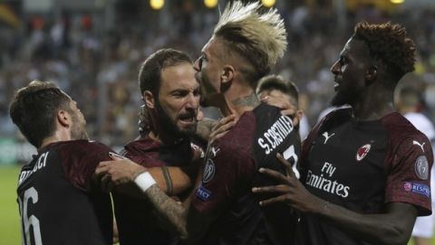 Milan players hug teammate Gonzalo Higuain, second left, who scored his side's first goal during a Group F Europa League soccer match between F91 Dudelange and AC Milan at the Josey Barthel stadium in Dudelange, Luxembourg, Thursday, Sept. 20, 2018. (AP Photo/Olivier Matthys)