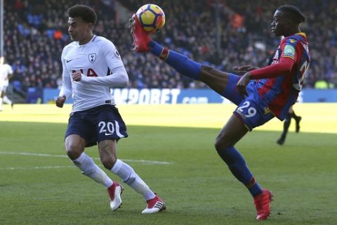 Tottenham Hotspur's Dele Alli, left, and Crystal Palace's Aaron Wan-Bissaka battle for the ball during the English Premier League soccer match between Crystal Palace and Tottenham Hotspur at Selhurst Park, London, Sunday, Feb. 25, 2018. (Steven Paston/PA via AP)