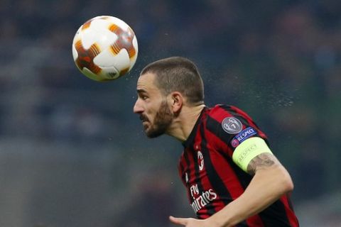 AC Milan's Leonardo Bonucci jumps for the ball during an Europa League round of 16, first leg, soccer match between AC Milan and Arsenal at the San Siro stadium in Milan, Italy, Friday, March 9, 2018. (AP Photo/Antonio Calanni)