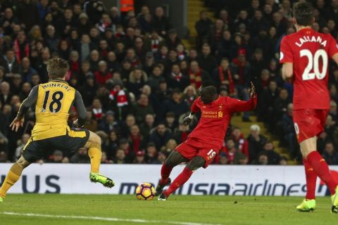 Liverpool's Sadio Mane, centre, shoots and scores his sides 2nd goal of the game during the English Premier League soccer match between Liverpool and Arsenal at Anfield, in Liverpool, England, Saturday, March 4, 2017.(AP Photo/Dave Thompson)