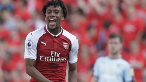 Arsenal's Alex Iwobi celebrates scoring his team's fourth goal during the English Premier League soccer match between Arsenal and Burnley at the Emirates Stadium in London, Sunday, May 6, 2018. The match is Arsenal manager Arsene Wenger's last home game in charge after announcing in April he will stand down as Arsenal coach at the end of the season after nearly 22 years at the helm. (AP Photo/Matt Dunham)