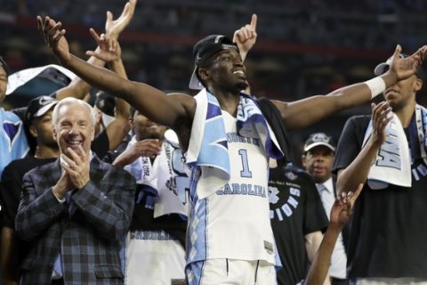 North Carolina's Theo Pinson (1) celerates with head coach Roy Williams and the rest of the players after the finals of the Final Four NCAA college basketball tournament against Gonzaga, Monday, April 3, 2017, in Glendale, Ariz. North Carolina won 71-65. (AP Photo/Mark Humphrey)