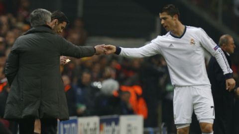 Real Madrid's Ronaldo, right, is grated by his coach Jose´ Mourinho after scoring against Galata Saray during a Champions League quarterfinal soccer match at Ali Sami Yen Spor Kompleksi in Istanbul, Turkey, Tuesday, April 9, 2013. (AP Photo/Thanassis Stavrakis)