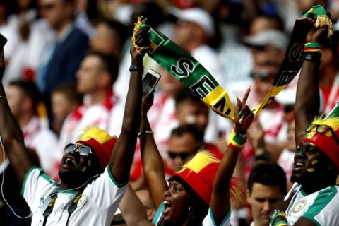 Senegal soccer fans sing their national anthem prior to the start of the group H match between Poland and Senegal at the 2018 soccer World Cup in the Spartak Stadium in Moscow, Russia, Tuesday, June 19, 2018. (AP Photo/Eduardo Verdugo)