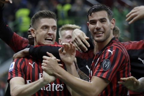 AC Milan's Krzysztof Piatek, left, celebrates his goal with teammates during a Serie A soccer match between AC Milan and Lecce, at the San Siro stadium in Milan, Italy, Sunday, Oct.20, 2019. (AP Photo/Luca Bruno)
