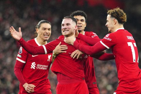 Liverpool's Alexis Mac Allister, centre, celebrates after scoring his side's second goal during the English Premier League soccer match between Liverpool and Sheffield United at the Anfield stadium in Liverpool, England, Thursday, Apr. 4, 2024. (AP Photo/Jon Super)