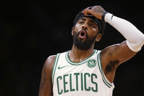 Boston Celtics guard Kyrie Irving reacts during the first quarter of a preseason basketball game against the Charlotte Hornets in Boston, Sunday, Sept. 30, 2018. (AP Photo/Charles Krupa)