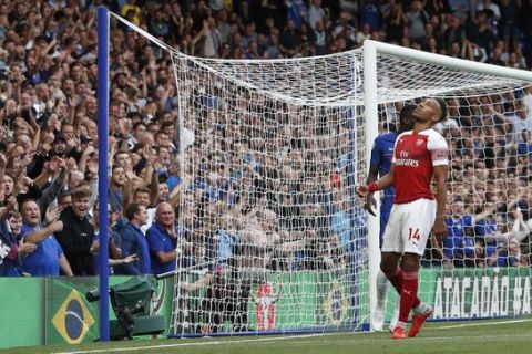 Arsenal's Pierre-Emerick Aubameyang reacts after missing during the English Premier League soccer match between Chelsea and Arsenal at Stamford bridge stadium in London, Saturday, Aug. 18, 2018. (AP Photo/Alastair Grant)