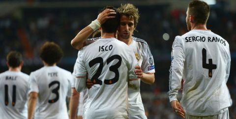 MADRID, SPAIN - APRIL 02:  Isco of Real Madrid is congratulated by Fabio Coentrao of Real Madrid after his goal during the UEFA Champions League Quarter Final first leg match between Real Madrid and Borussia Dortmund at Estadio Santiago Bernabeu on April 2, 2014 in Madrid, Spain.  (Photo by Dennis Grombkowski/Bongarts/Getty Images)