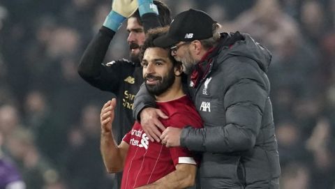 Liverpool's manager Jurgen Klopp, right, and Liverpool's Mohamed Salah celebrate after winning the English Premier League soccer match between Liverpool and Manchester United at Anfield Stadium in Liverpool, Sunday, Jan. 19, 2020.(AP Photo/Jon Super)