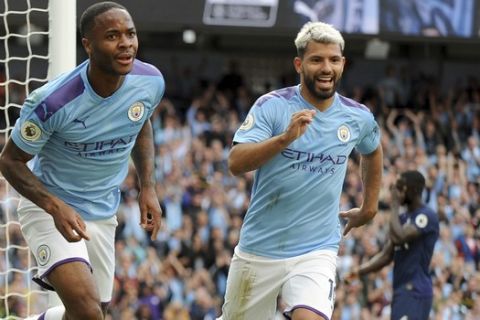 Manchester City's Raheem Sterling, left, celebrates with Manchester City's Sergio Aguero after scoring his side's opening goal during the English Premier League soccer match between Manchester City and Tottenham Hotspur at Etihad stadium in Manchester, England, Saturday, Aug. 17, 2019. (AP Photo/Rui Vieira)