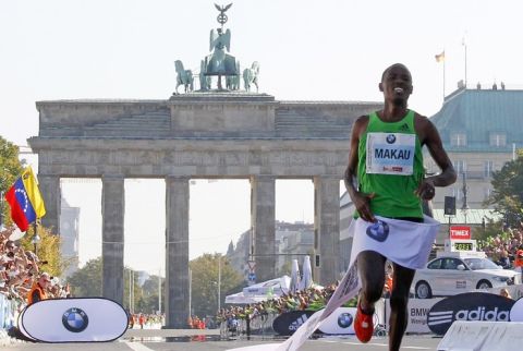 Patrick Makau of Kenya crosses the finish line to win the 38th Berlin Marathon September 25, 2011.  Makau unofficially broke the world men's marathon record on Sunday when he clocked two hours, three minutes and 38 seconds in the Berlin marathon.      REUTERS/Tobias Schwarz (GERMANY - Tags: SPORT ATHLETICS)