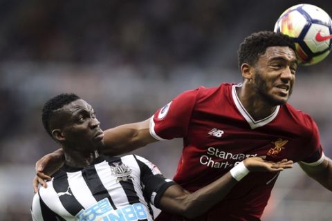 Liverpool's Joe Gomez, right, and Newcastle United's Christian Atsu battle for the ball during the English Premier League soccer match at St James' Park, Newcastle, England, Sunday, Oct. 1, 2017. (Owen Humphreys/PA via AP)