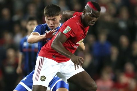 Rochdale's Aaron Morley, left, and Manchester United's Paul Pogba battle for the ball during their English League Cup, Third Round soccer match at Old Trafford, Manchester, England, Wednesday, Sept. 25, 2019. (Richard Sellers/PA via AP)