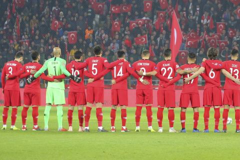 Sweden, right, and Turkey teams stand during one minute silence for memory of former Turkish national team head coach Metin Turel at the beginning of the UEFA Nations League soccer match between Turkey and Sweden in Konya, Turkey, Saturday, Nov. 17, 2018. (AP Photo)