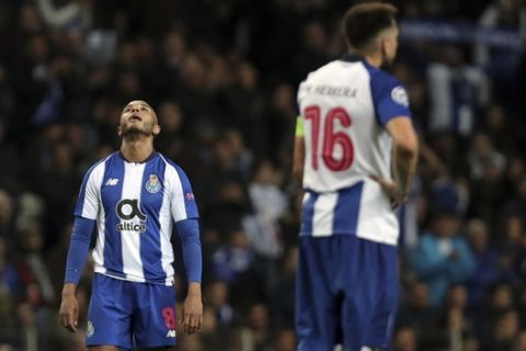 Porto midfielder Yacine Brahimi, left, and Porto midfielder Hector Herrera react during the Champions League quarterfinals, 2nd leg, soccer match between FC Porto and Liverpool at the Dragao stadium in Porto, Portugal, Wednesday, April 17, 2019. (AP Photo/Luis Vieira)