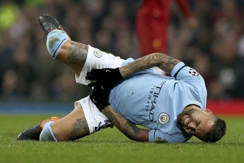 Manchester City's Nicolas Otamendi goes down from a challenge during the  Champions League, quarterfinal second leg soccer match against Liverpool at the Etihad Stadium, Manchester, England Tuesday April 10, 2018. (Tim Goode/PA via AP)