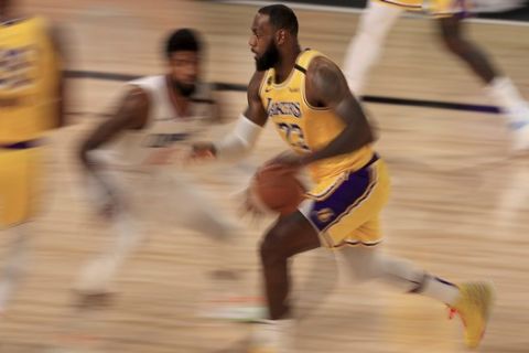 Los Angeles Lakers LeBron James (23) drives to the basket against the Los Angeles Clippers during the second quarter of an NBA basketball game Thursday, July 30, 2020, in Lake Buena Vista, Fla.  (Mike Ehrmann/Pool Photo via AP)
