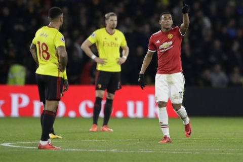 Manchester United's Anthony Martial, right, celebrates scoring his side's third goal during the English Premier League soccer match between Watford and Manchester United at Vicarage Road stadium in Watford, Tuesday, Nov. 28, 2017. (AP Photo/Matt Dunham)