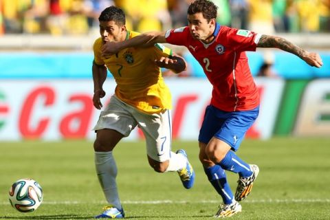 BELO HORIZONTE, BRAZIL - JUNE 28: Eugenio Mena of Chile challenges Hulk of Brazil during the 2014 FIFA World Cup Brazil round of 16 match between Brazil and Chile at Estadio Mineirao on June 28, 2014 in Belo Horizonte, Brazil.  (Photo by Quinn Rooney/Getty Images)